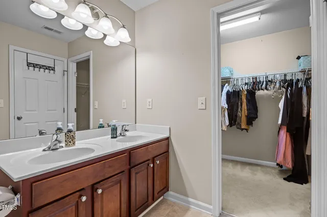 a bathroom with a sink vanity and a mirror