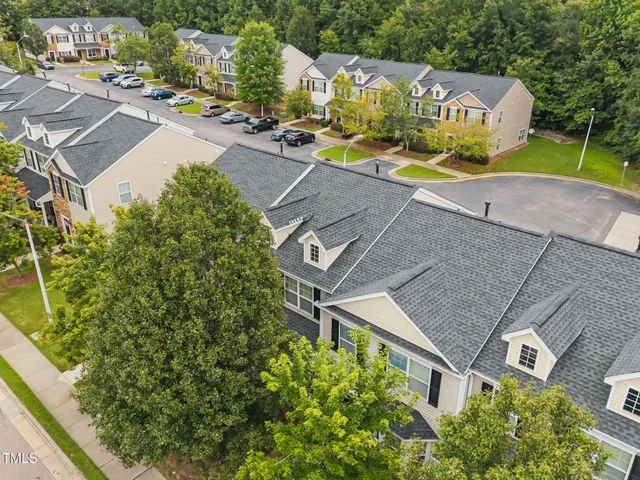an aerial view of a house with garden space and street view