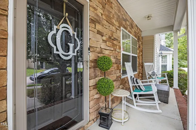 a dining room with furniture and a floor to ceiling window