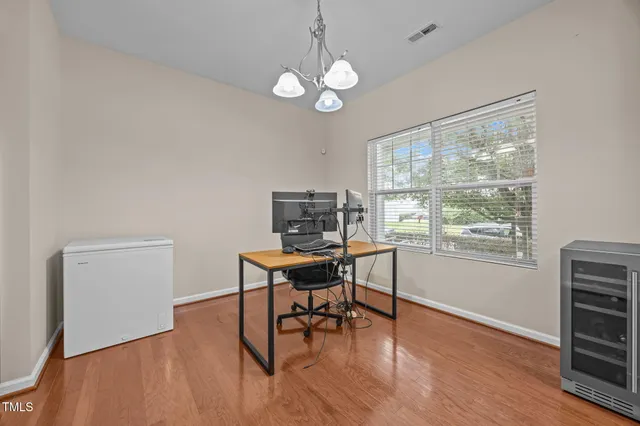 a view of a workspace with furniture and a window