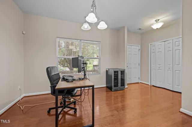 a view of a workspace with furniture and a window