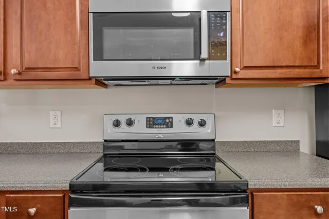 a stove top oven sitting inside of a kitchen