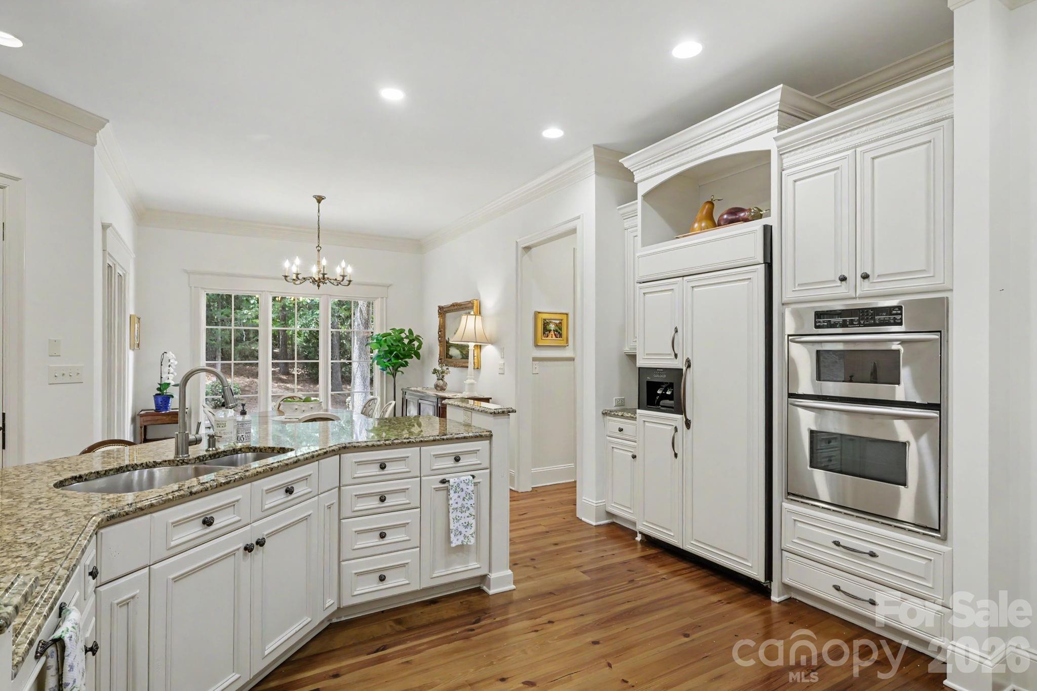 508 Hideaway Ridge Court Matthews, NC 28105 - Photo 21 of 47 a kitchen with white cabinets and stainless steel appliances