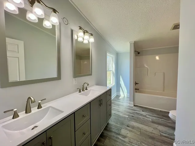 a bathroom with a sink double vanity granite tub and shower