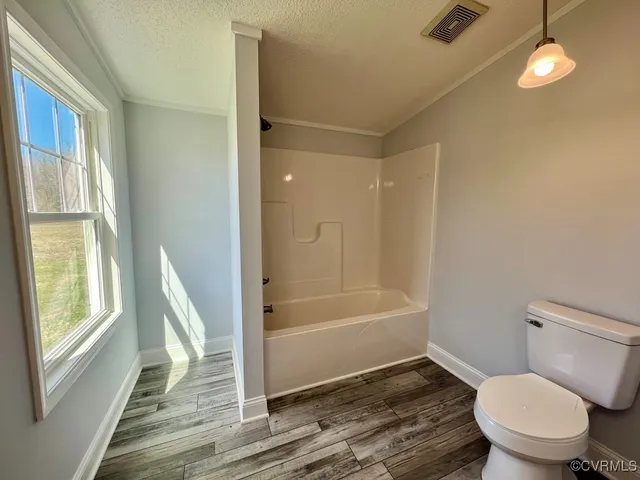 a bathroom with a toilet and a bathtub
