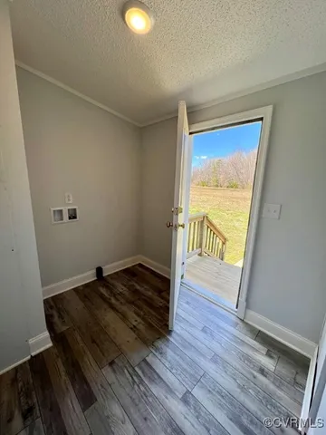 a view of an empty room and wooden floor