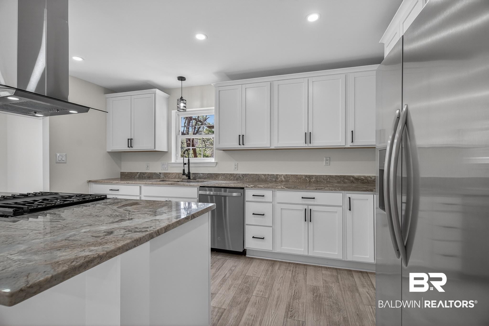 10650 Old Pascagoula Road Theodore, AL 36582 - Photo 21 of 77 Kitchen with stainless steel appliances, island exhaust hood, pendant lighting, dark stone countertops, and white cabinetry