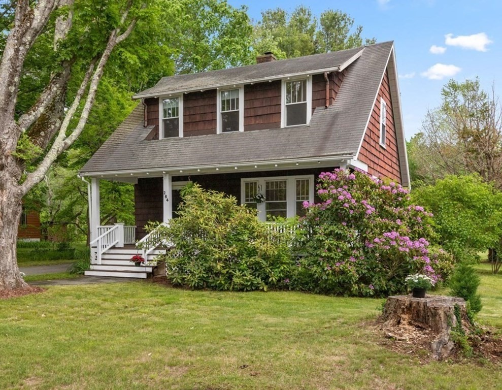 264 Lincoln Road Lincoln, MA 01773 - Photo 1 of 31 a front view of a house with a garden