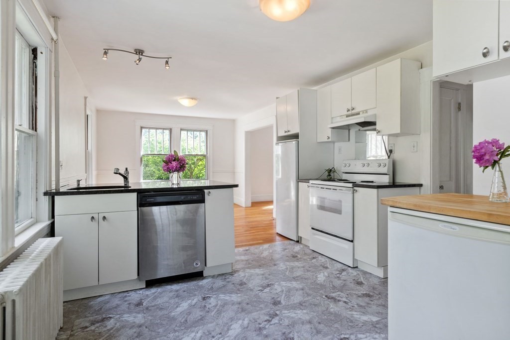 264 Lincoln Road Lincoln, MA 01773 - Photo 13 of 31 a kitchen with white cabinets and stainless steel appliances