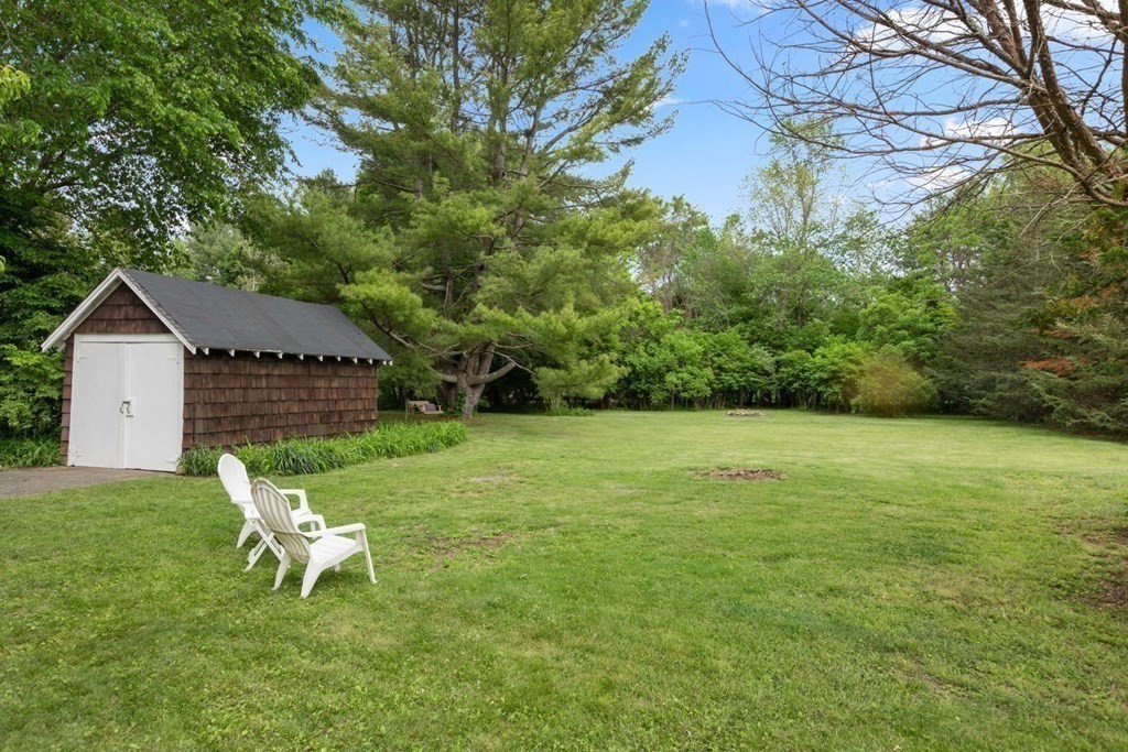 264 Lincoln Road Lincoln, MA 01773 - Photo 23 of 31 a white bench sitting in the middle of a field