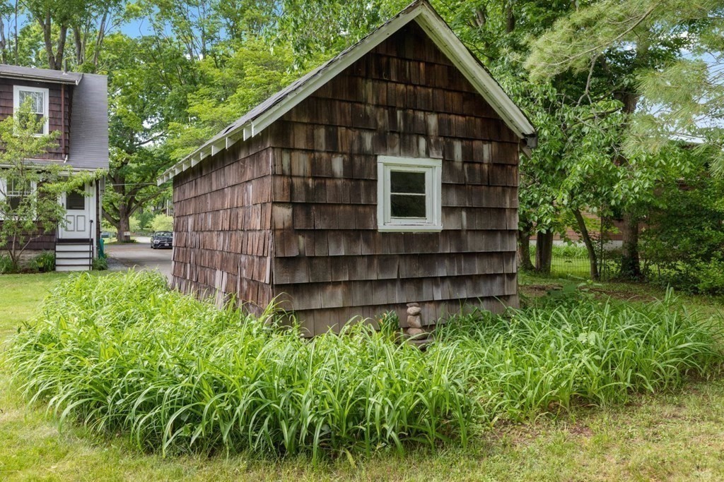 264 Lincoln Road Lincoln, MA 01773 - Photo 26 of 31 a wooden house with tall trees in the background