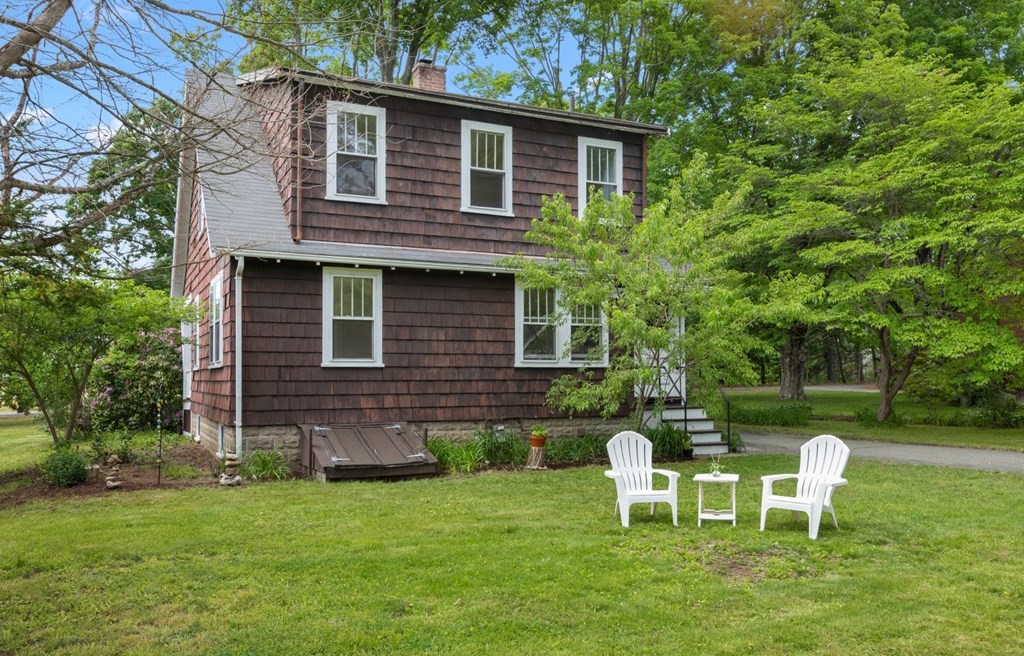 264 Lincoln Road Lincoln, MA 01773 - Photo 27 of 31 a view of a house with a yard chairs and a table