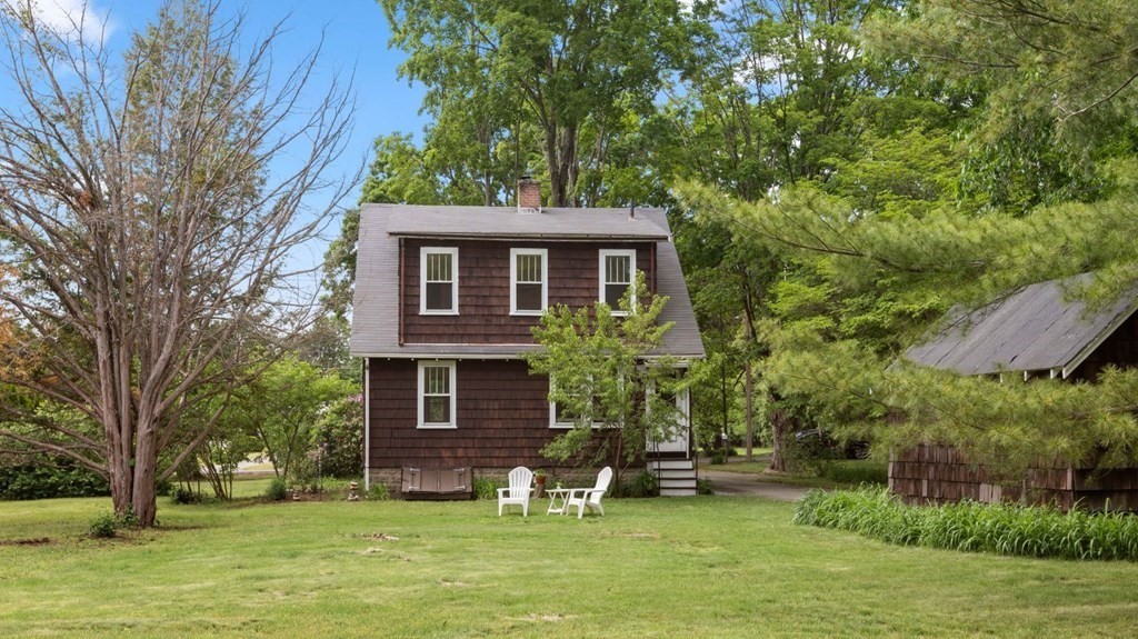 264 Lincoln Road Lincoln, MA 01773 - Photo 29 of 31 a front view of a house with a garden and trees