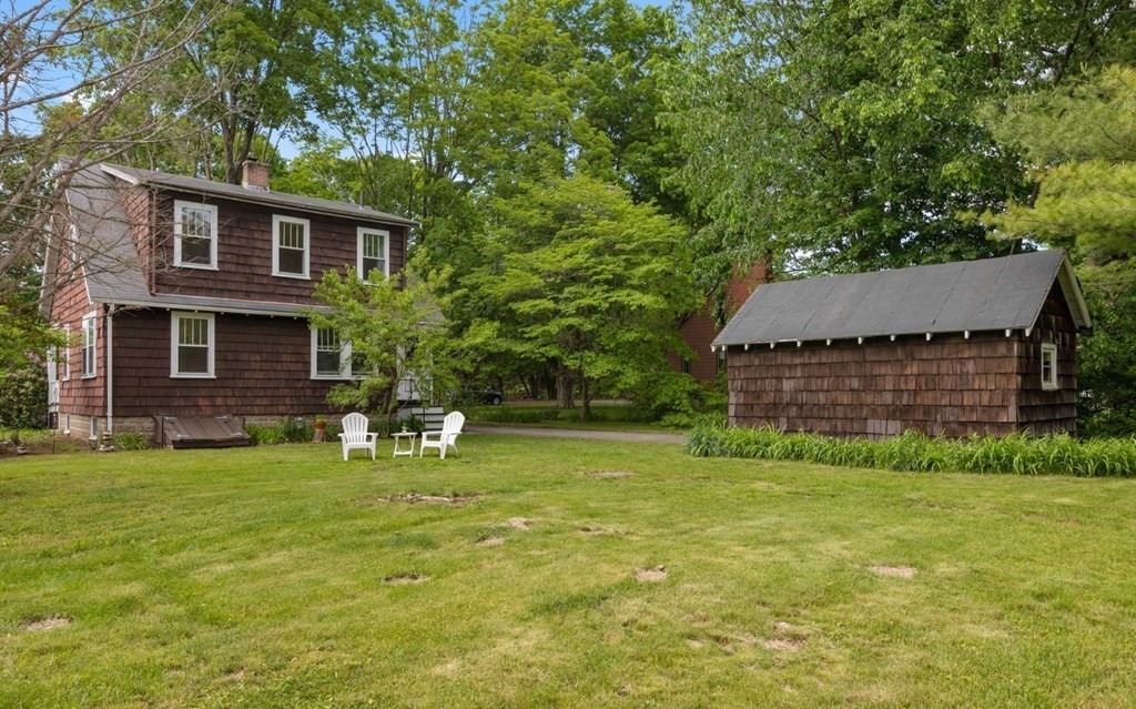 264 Lincoln Road Lincoln, MA 01773 - Photo 30 of 31 a backyard of a house with table and chairs