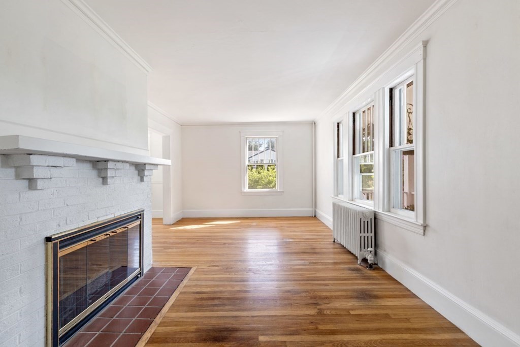 264 Lincoln Road Lincoln, MA 01773 - Photo 6 of 31 a view of an empty room with wooden floor fireplace and a window