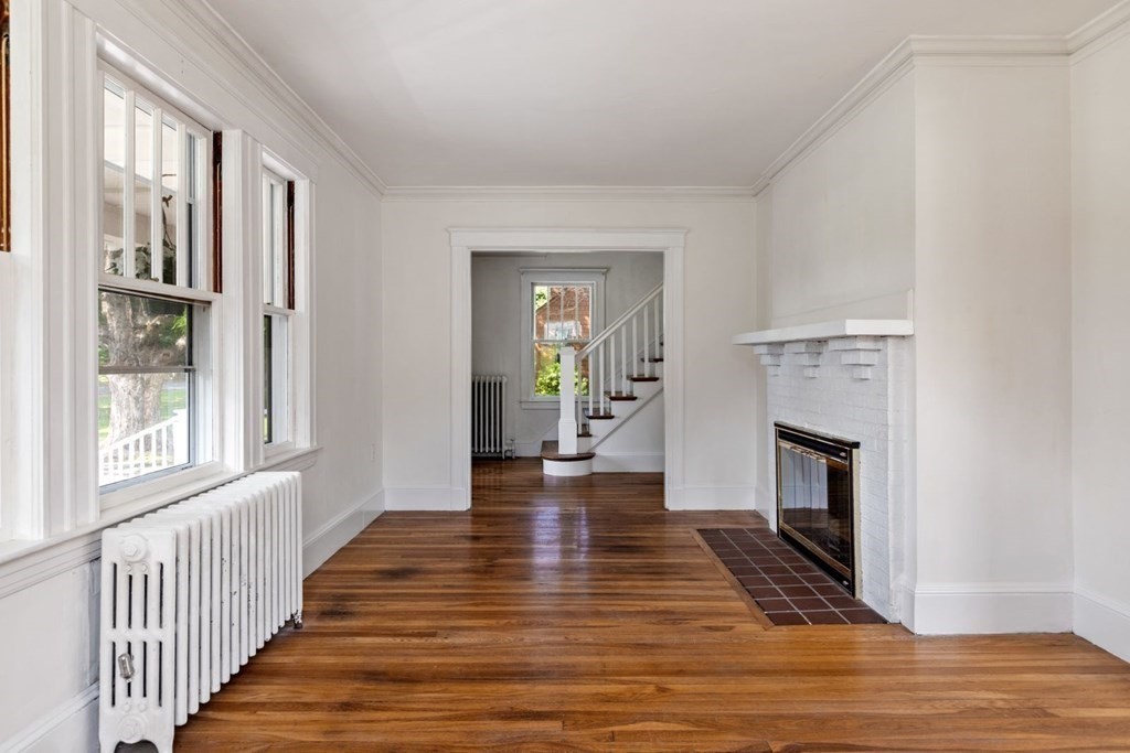 264 Lincoln Road Lincoln, MA 01773 - Photo 7 of 31 a view of a livingroom with wooden floor and a fireplace