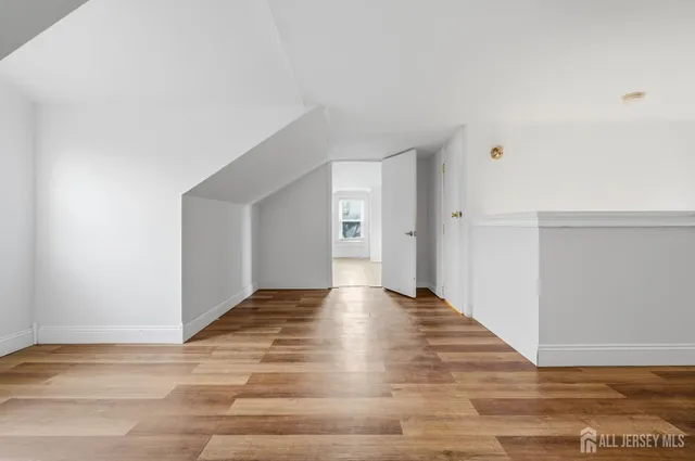a view of an empty room and wooden floor