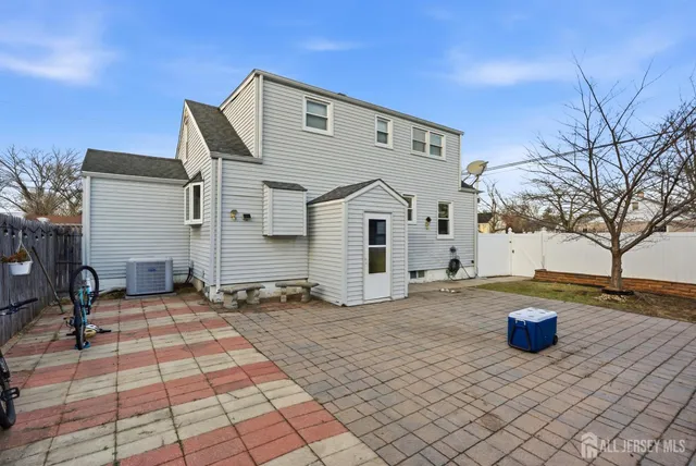 a view of a white house with a sink and a yard