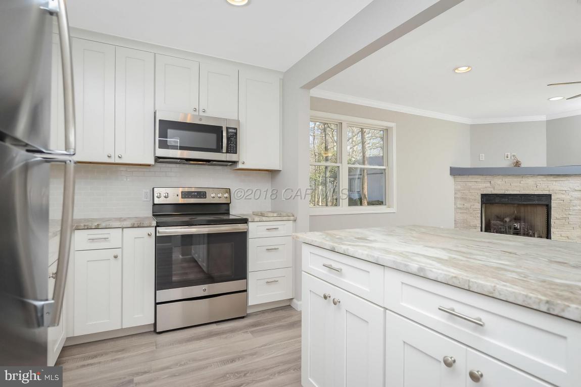 45 Abbyshire Road Ocean Pines, MD 21811 - Photo 12 of 37 a kitchen with stainless steel appliances granite countertop a stove a microwave and a white cabinets