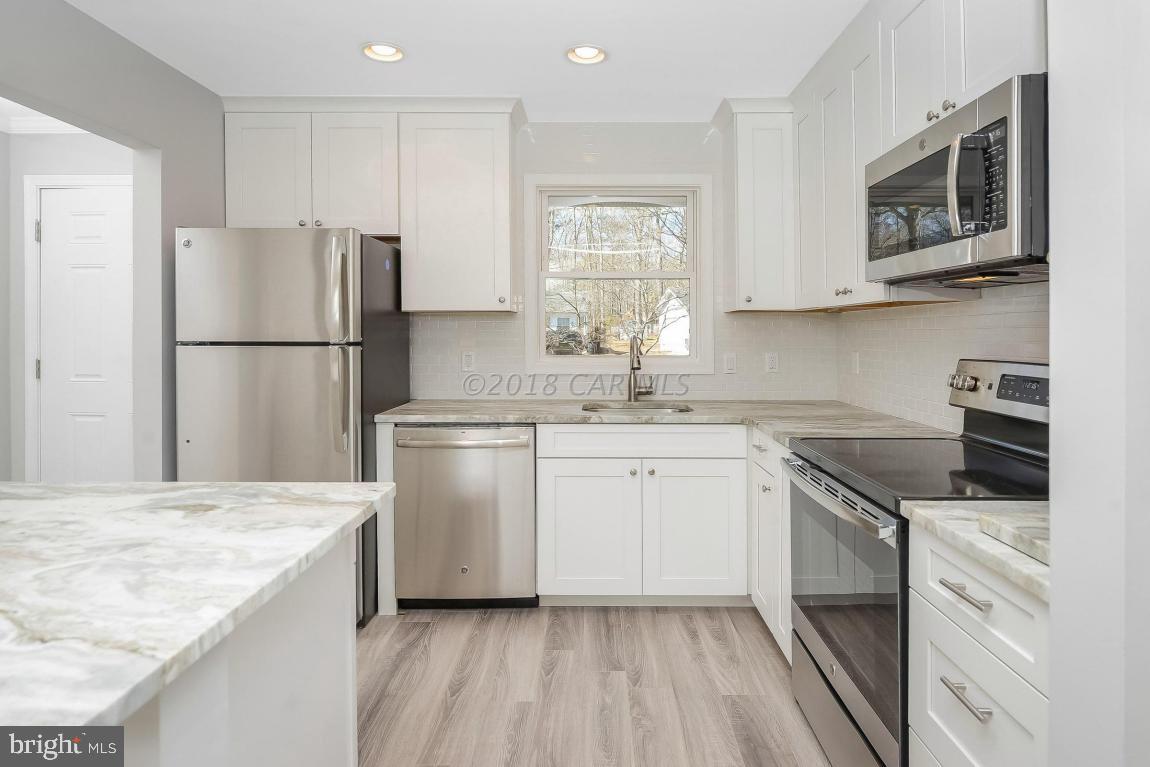 45 Abbyshire Road Ocean Pines, MD 21811 - Photo 13 of 37 a kitchen with a sink stove and refrigerator