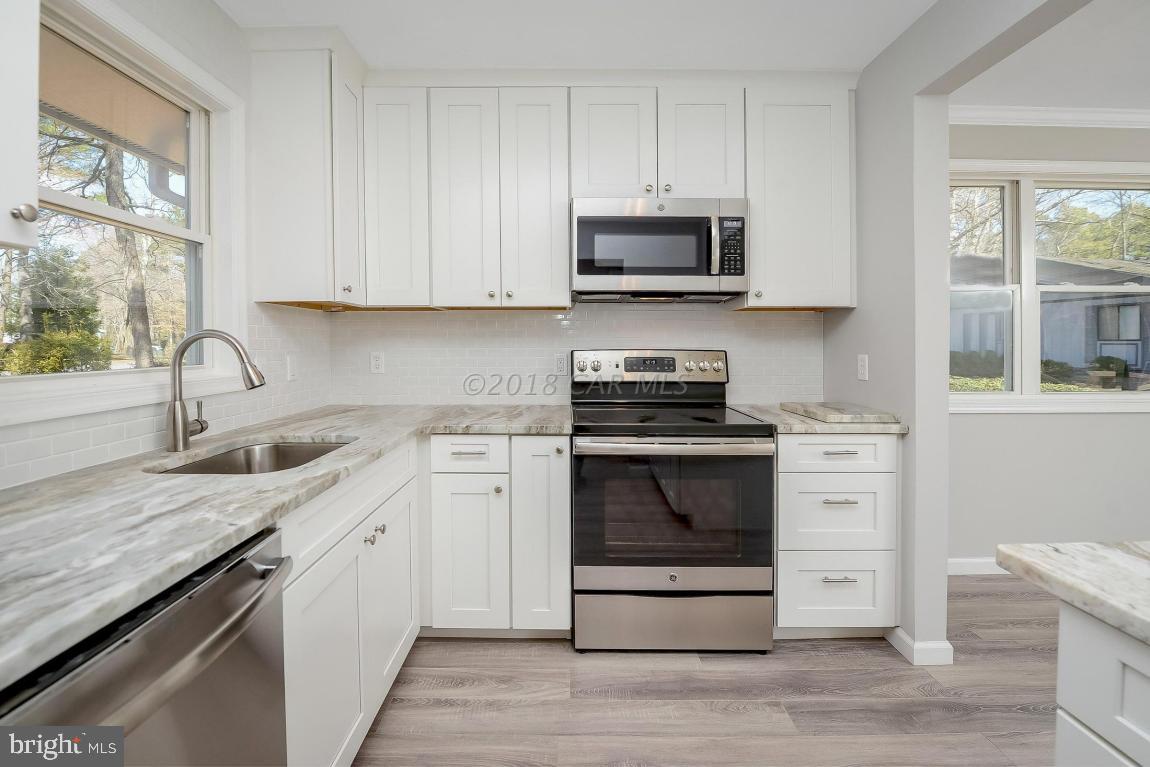 45 Abbyshire Road Ocean Pines, MD 21811 - Photo 14 of 37 a kitchen with white cabinets stainless steel appliances and sink