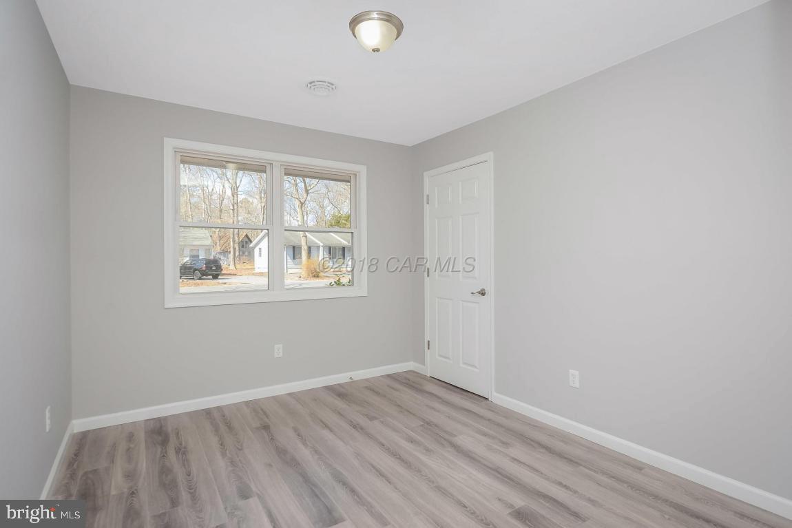 45 Abbyshire Road Ocean Pines, MD 21811 - Photo 16 of 37 an empty room with wooden floor and windows