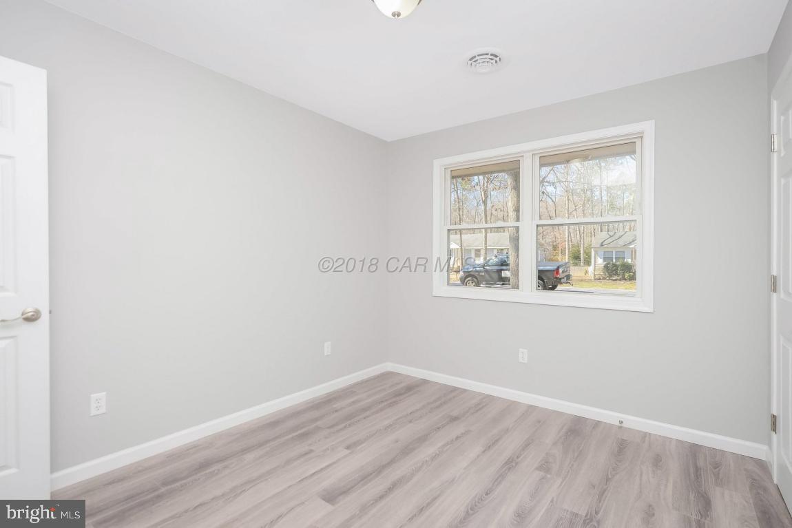 45 Abbyshire Road Ocean Pines, MD 21811 - Photo 17 of 37 an empty room with wooden floor and windows
