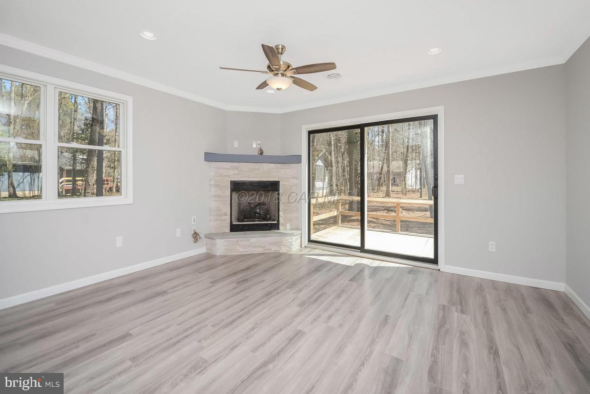 45 Abbyshire Road Ocean Pines, MD 21811 - Photo 3 of 37 a view of an empty room with wooden floor and a window