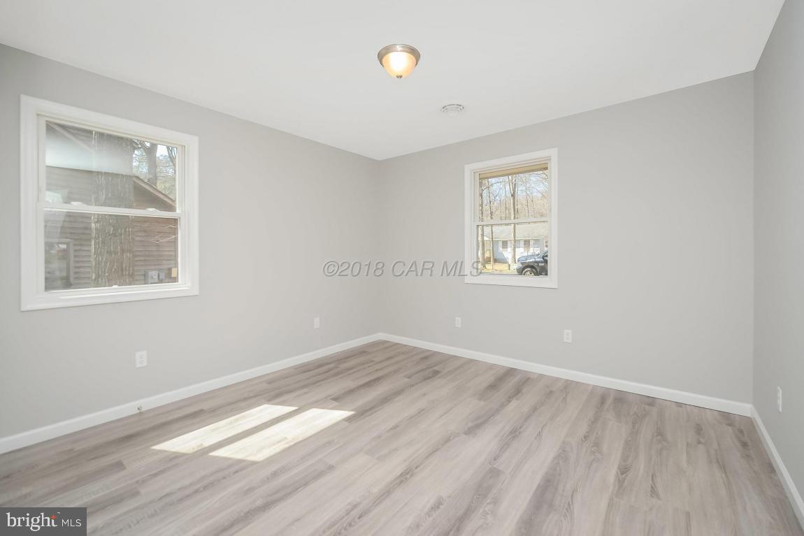 45 Abbyshire Road Ocean Pines, MD 21811 - Photo 24 of 37 an empty room with wooden floor and windows