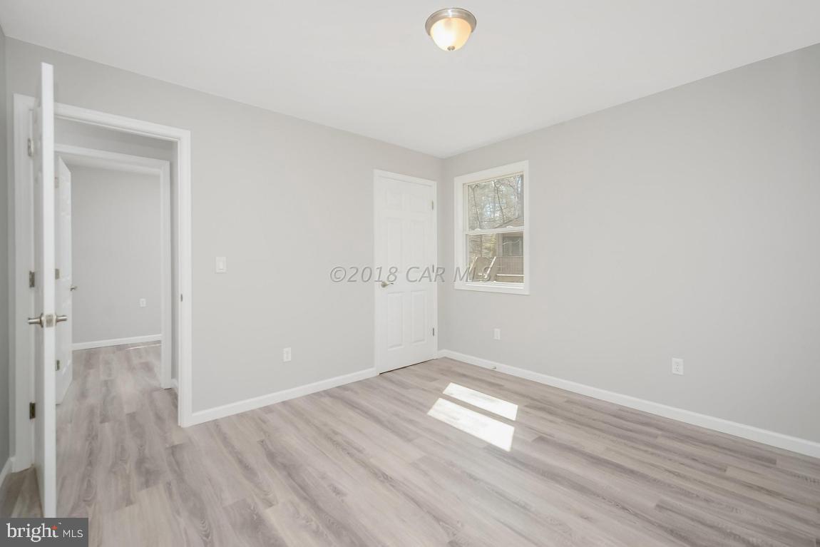 45 Abbyshire Road Ocean Pines, MD 21811 - Photo 27 of 37 an empty room with wooden floor and windows