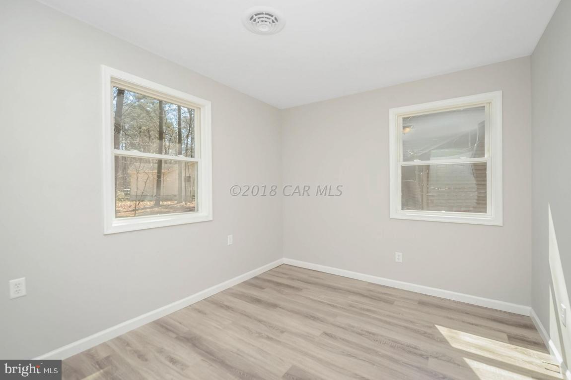 45 Abbyshire Road Ocean Pines, MD 21811 - Photo 28 of 37 a view of an empty room with wooden floor and a window