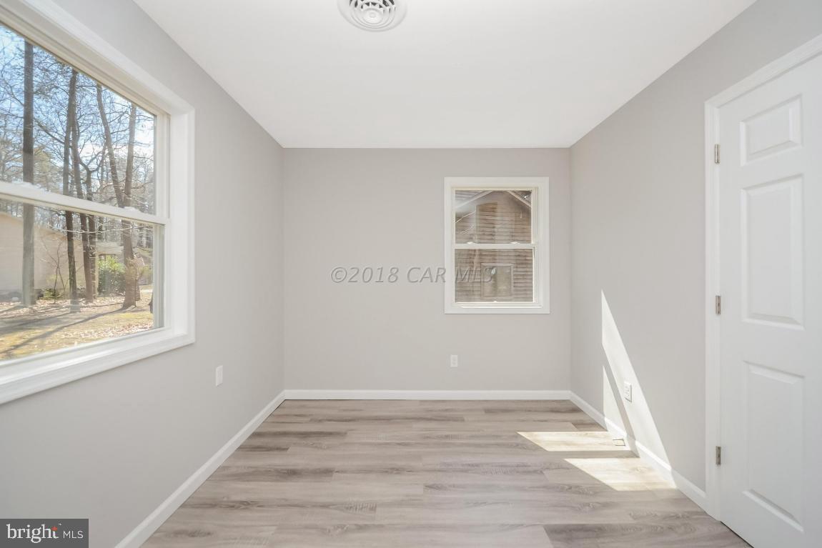 45 Abbyshire Road Ocean Pines, MD 21811 - Photo 29 of 37 a view of an empty room with wooden floor and a window