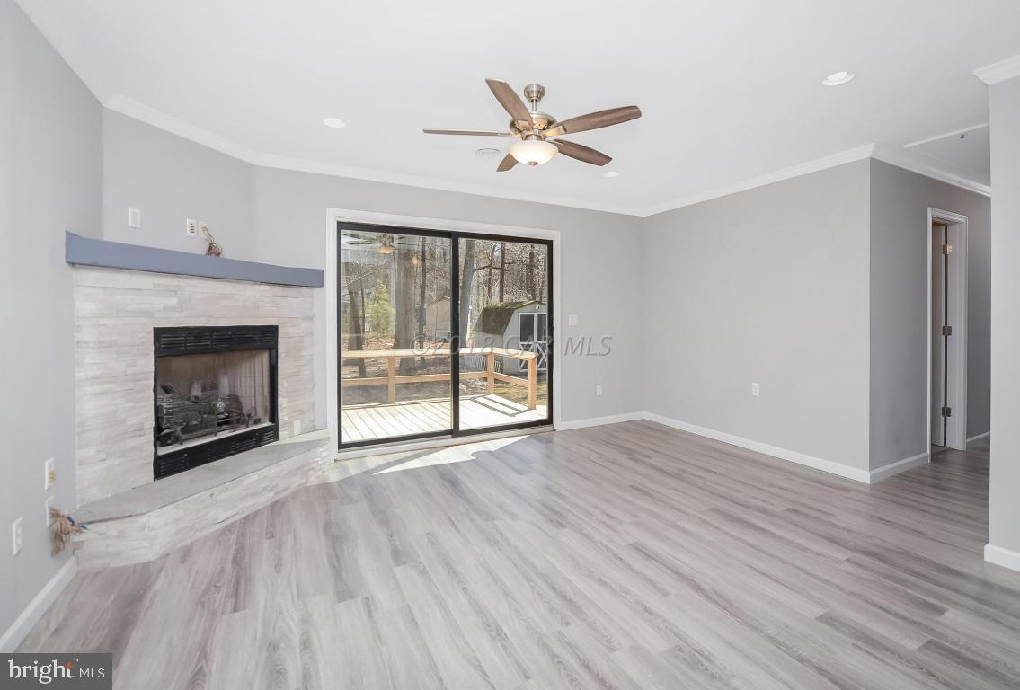 45 Abbyshire Road Ocean Pines, MD 21811 - Photo 4 of 37 a view of an empty room with wooden floor fireplace and a window