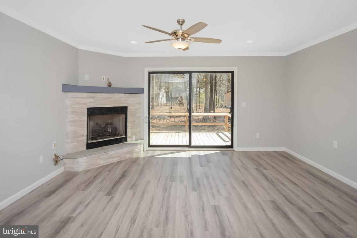 45 Abbyshire Road Ocean Pines, MD 21811 - Photo 5 of 37 wooden floor fireplace and windows in an empty room