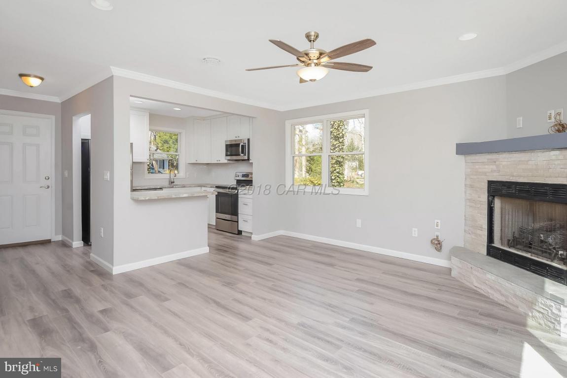 45 Abbyshire Road Ocean Pines, MD 21811 - Photo 8 of 37 a view of a kitchen with wooden floor and a fireplace