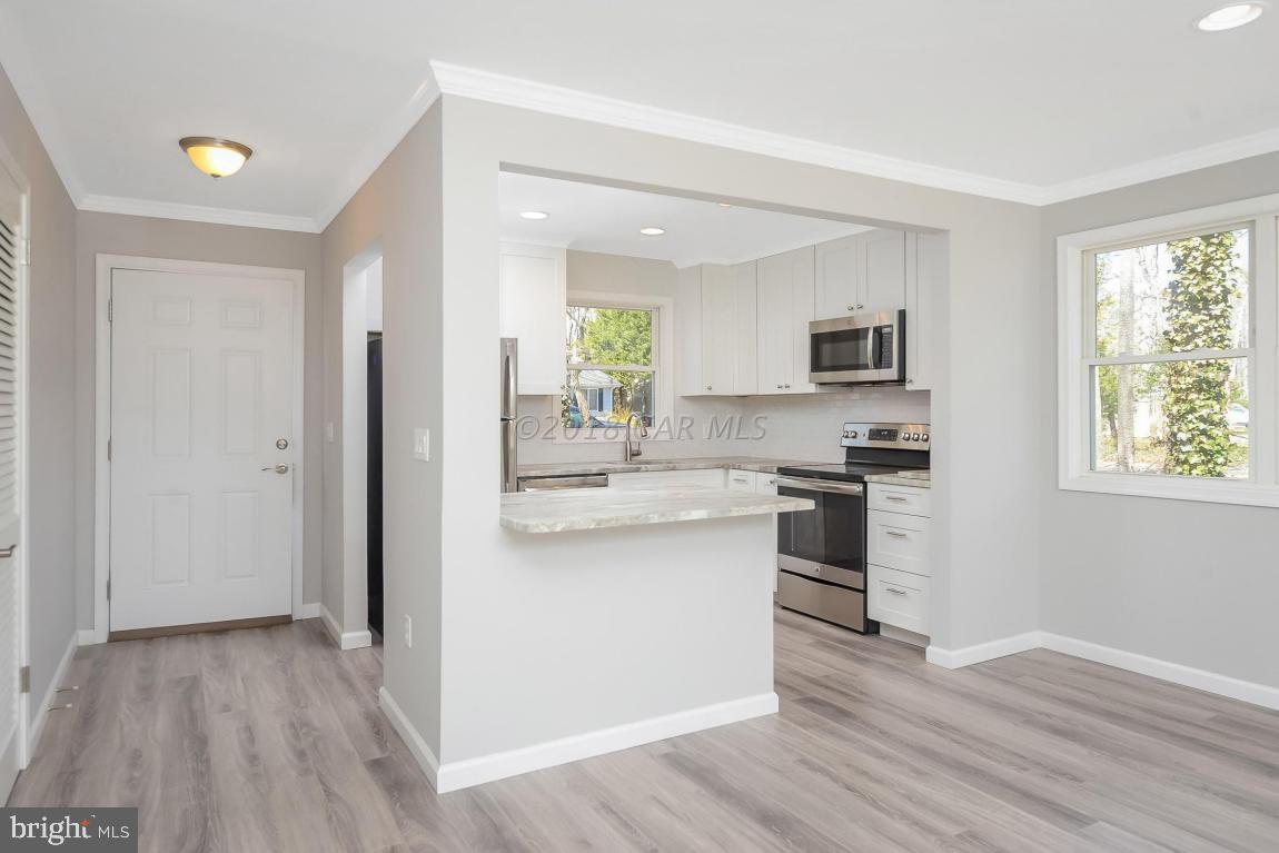 45 Abbyshire Road Ocean Pines, MD 21811 - Photo 10 of 37 a kitchen with white cabinets and appliances