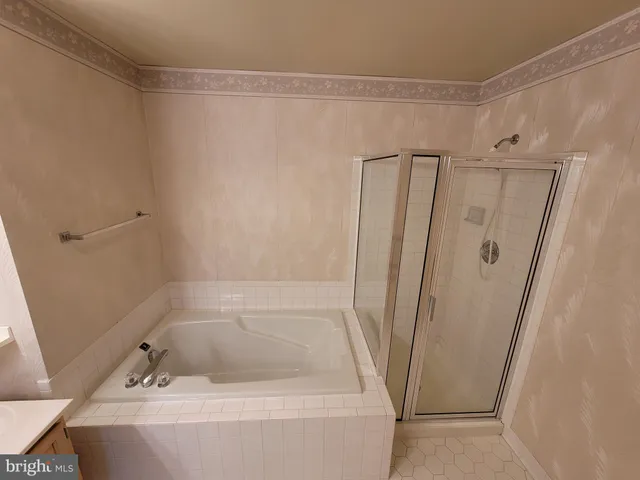 a bathroom with a tub and a shower