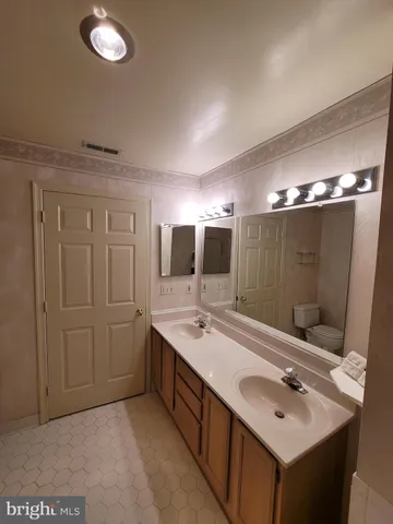 a bathroom with a double vanity sink and a mirror