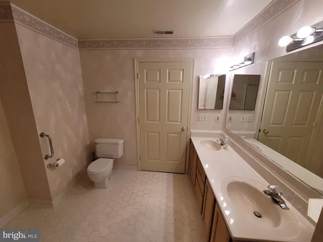 a bathroom with a sink toilet a mirror and shower