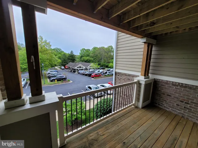 a view of a balcony with wooden floor