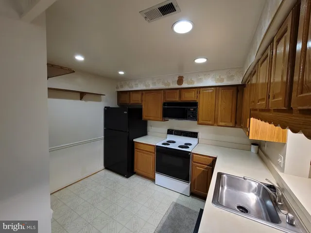 a kitchen with a refrigerator and a sink