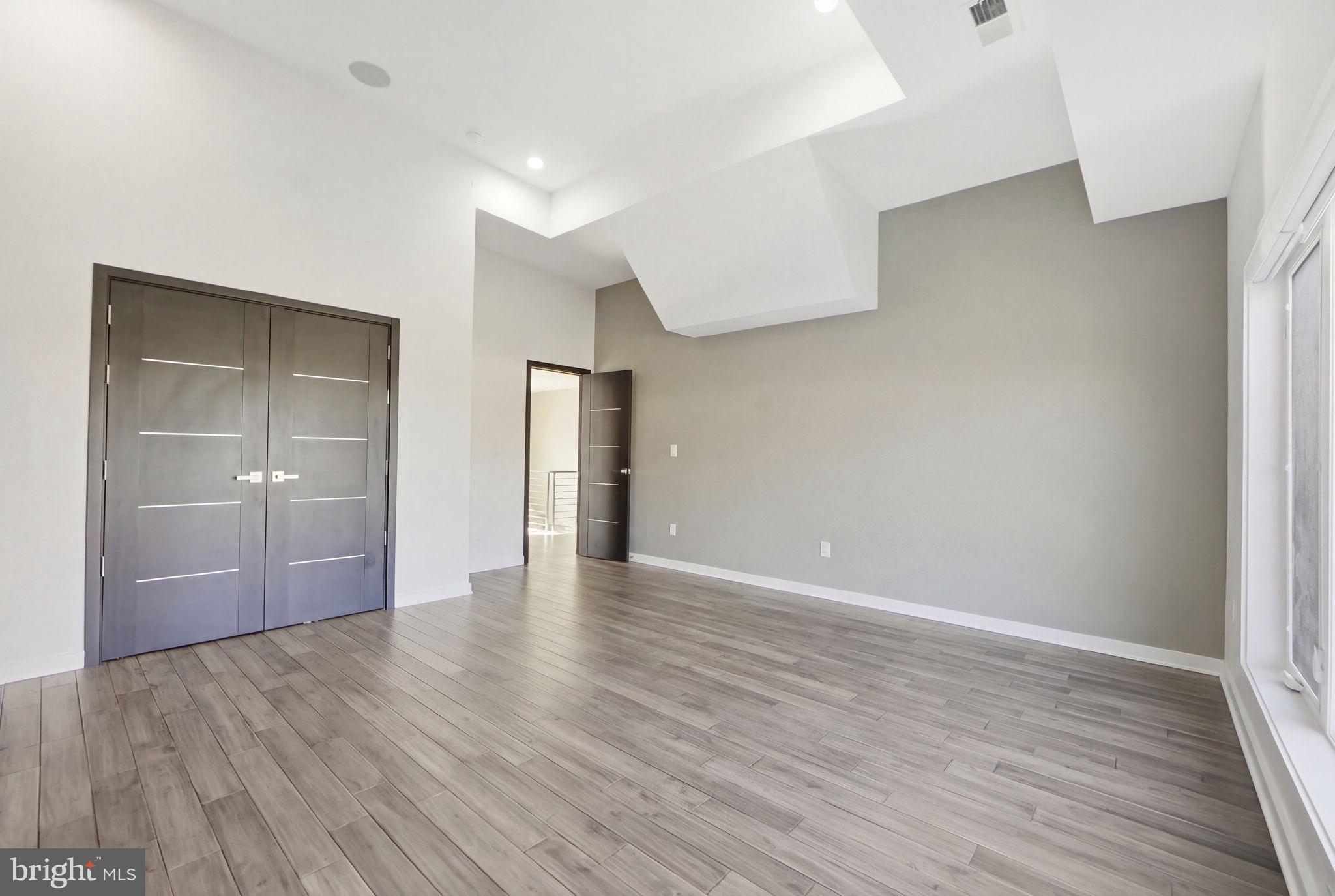 2368 Hunter Mill Road Vienna, VA 22181 - Photo 67 of 74 a view of an empty room with closet and wooden floor