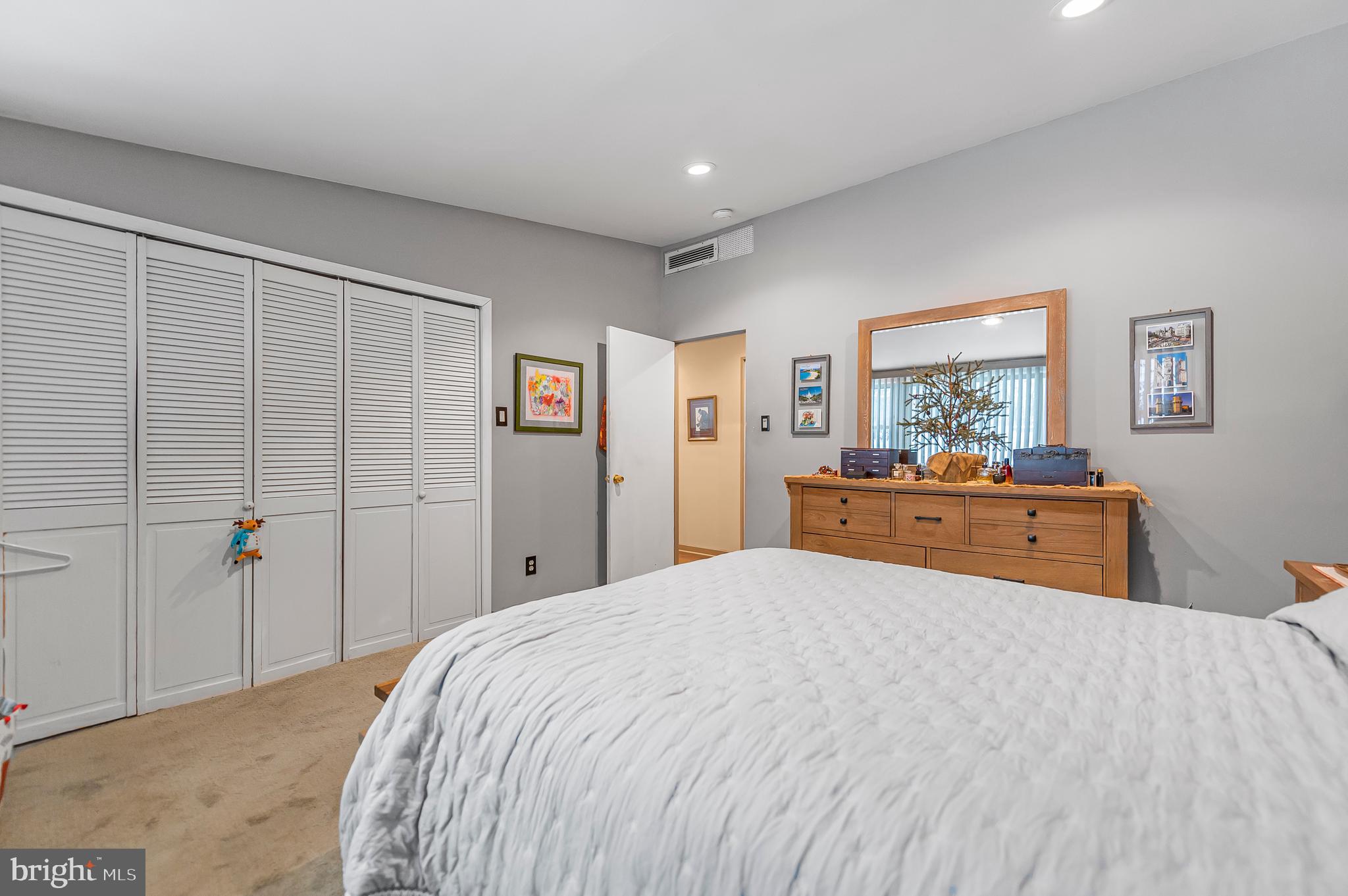 2409 Ashbourne Road Wyncote, PA 19095 - Photo 15 of 36 a bedroom with a large bed and a dresser