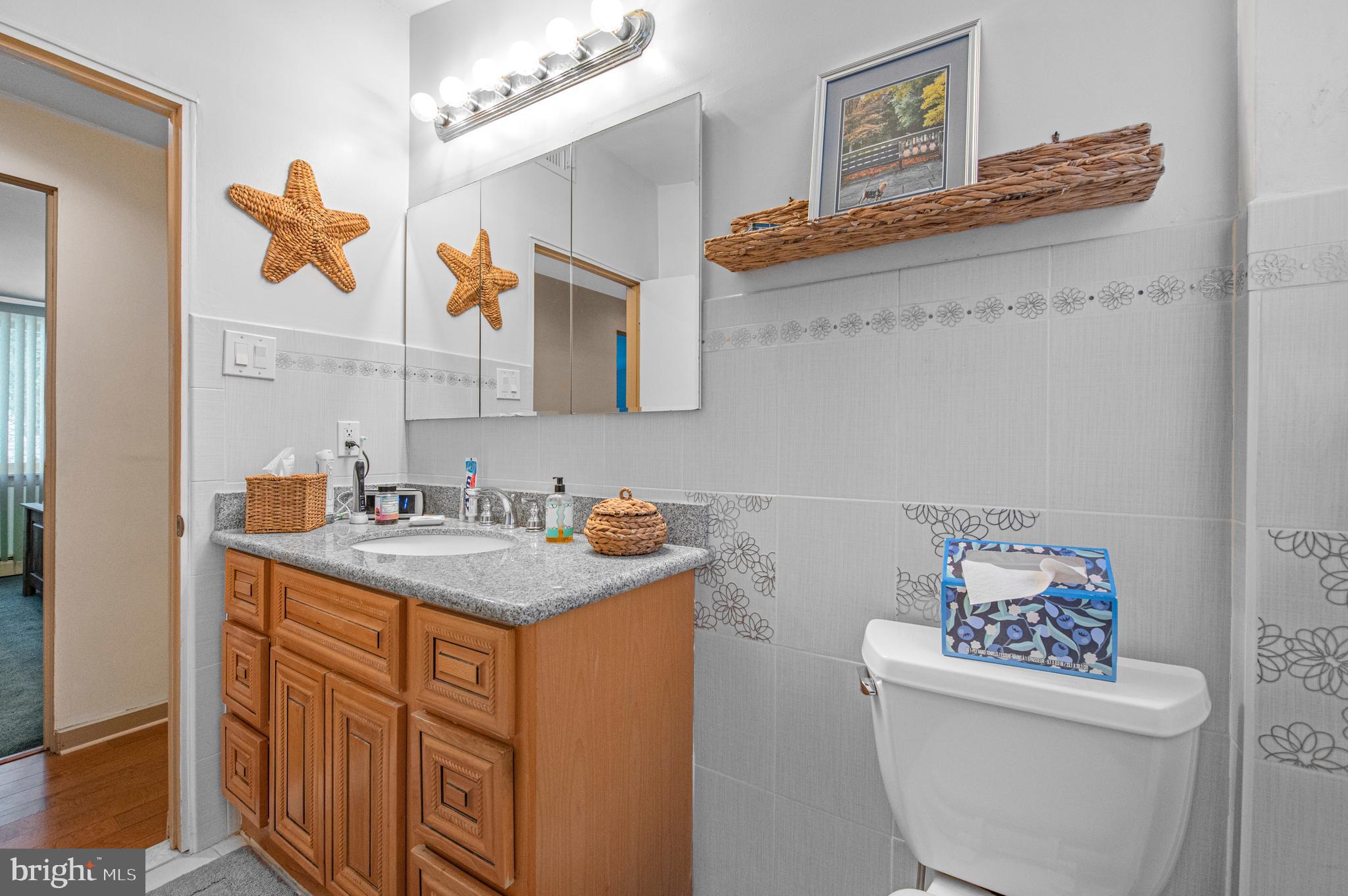 2409 Ashbourne Road Wyncote, PA 19095 - Photo 19 of 36 a bathroom with a sink a toilet and mirror