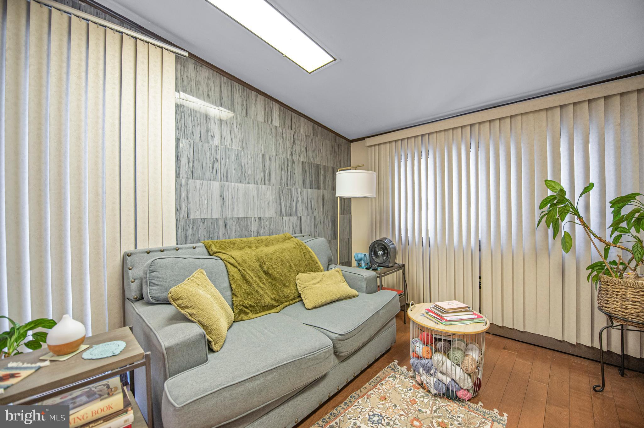 2409 Ashbourne Road Wyncote, PA 19095 - Photo 27 of 36 a living room with furniture and a potted plant