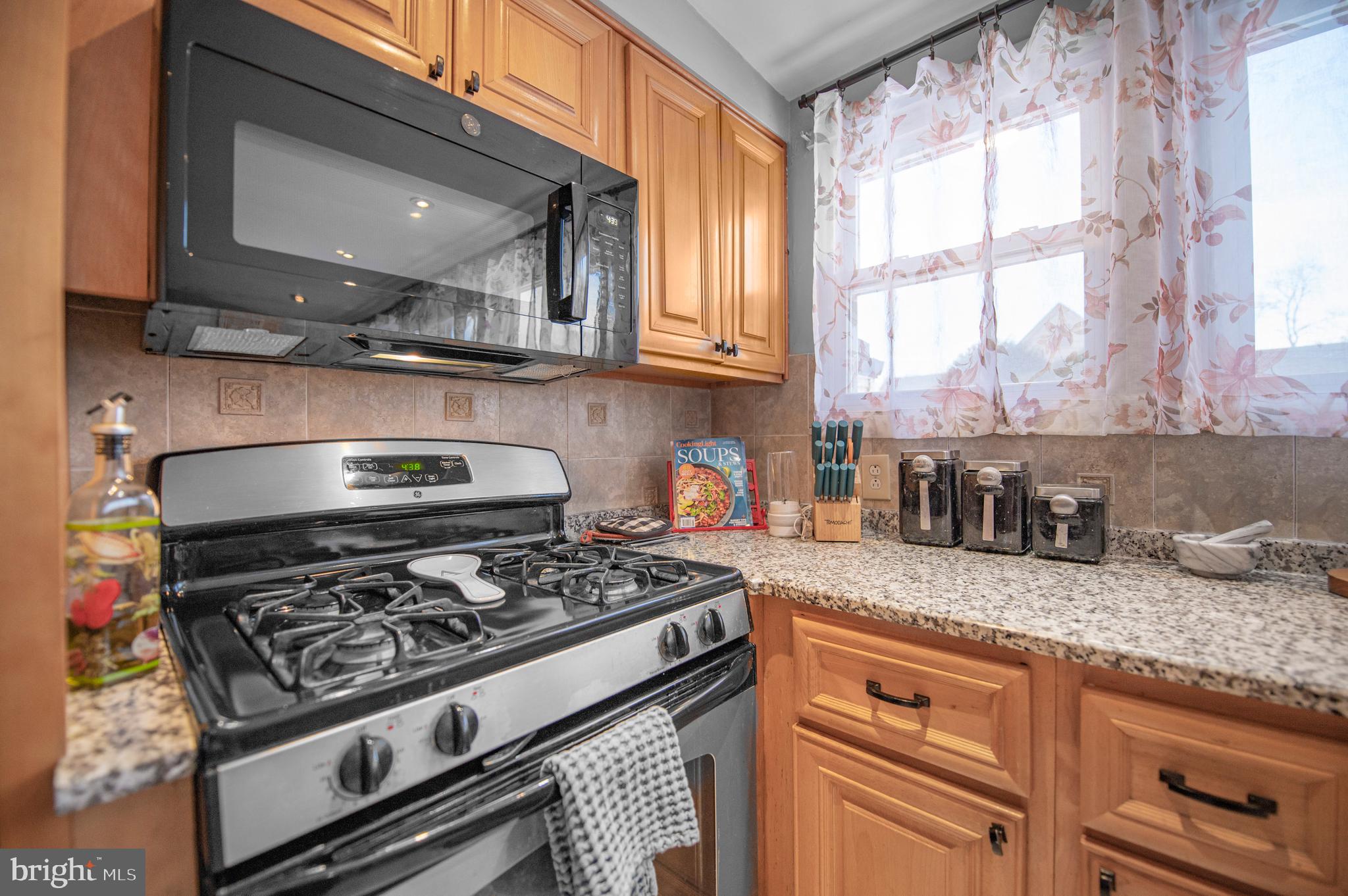 2409 Ashbourne Road Wyncote, PA 19095 - Photo 3 of 36 a kitchen with granite countertop a stove and a sink