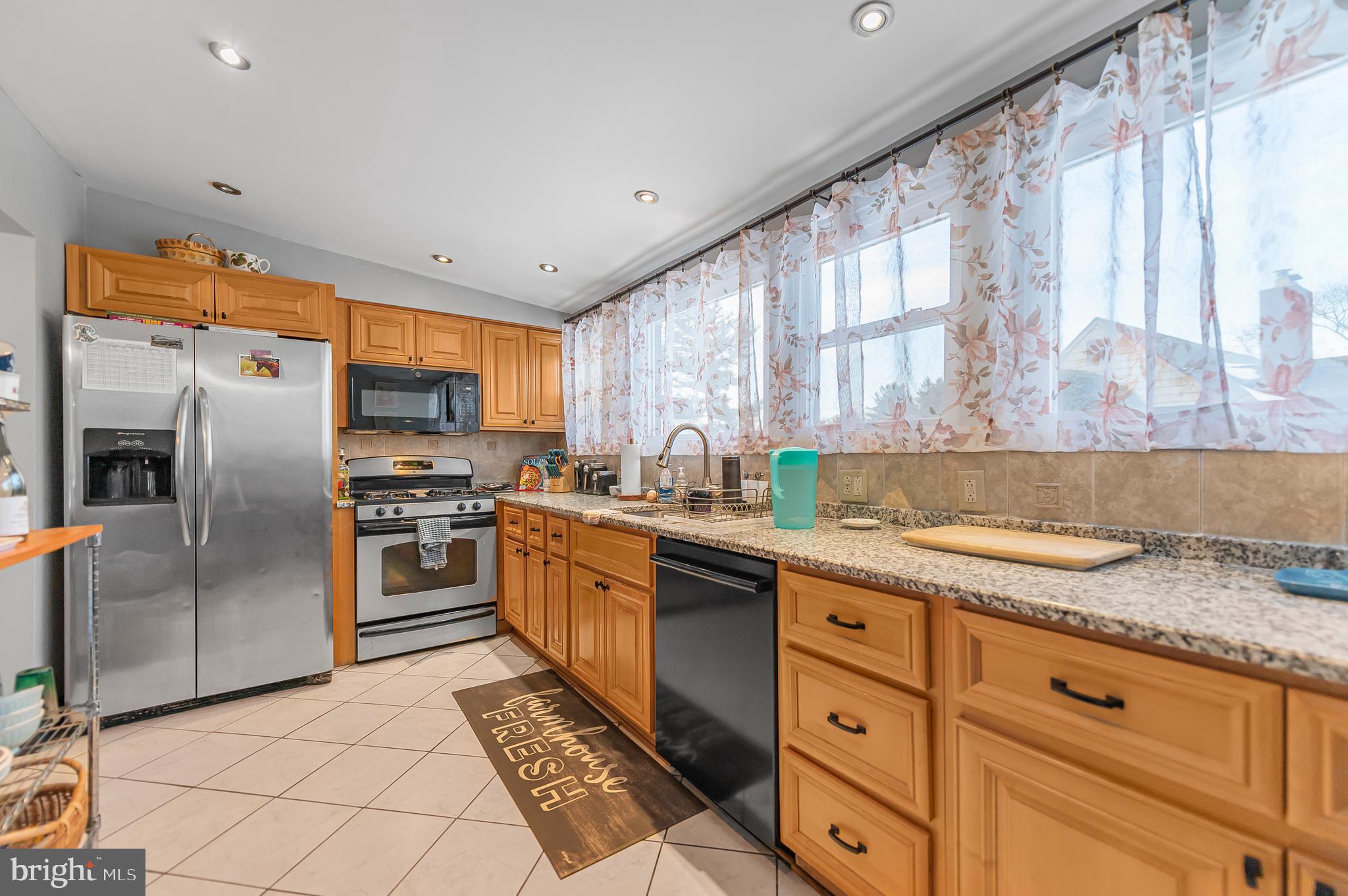 2409 Ashbourne Road Wyncote, PA 19095 - Photo 6 of 36 a kitchen with granite countertop a refrigerator oven a sink and dishwasher