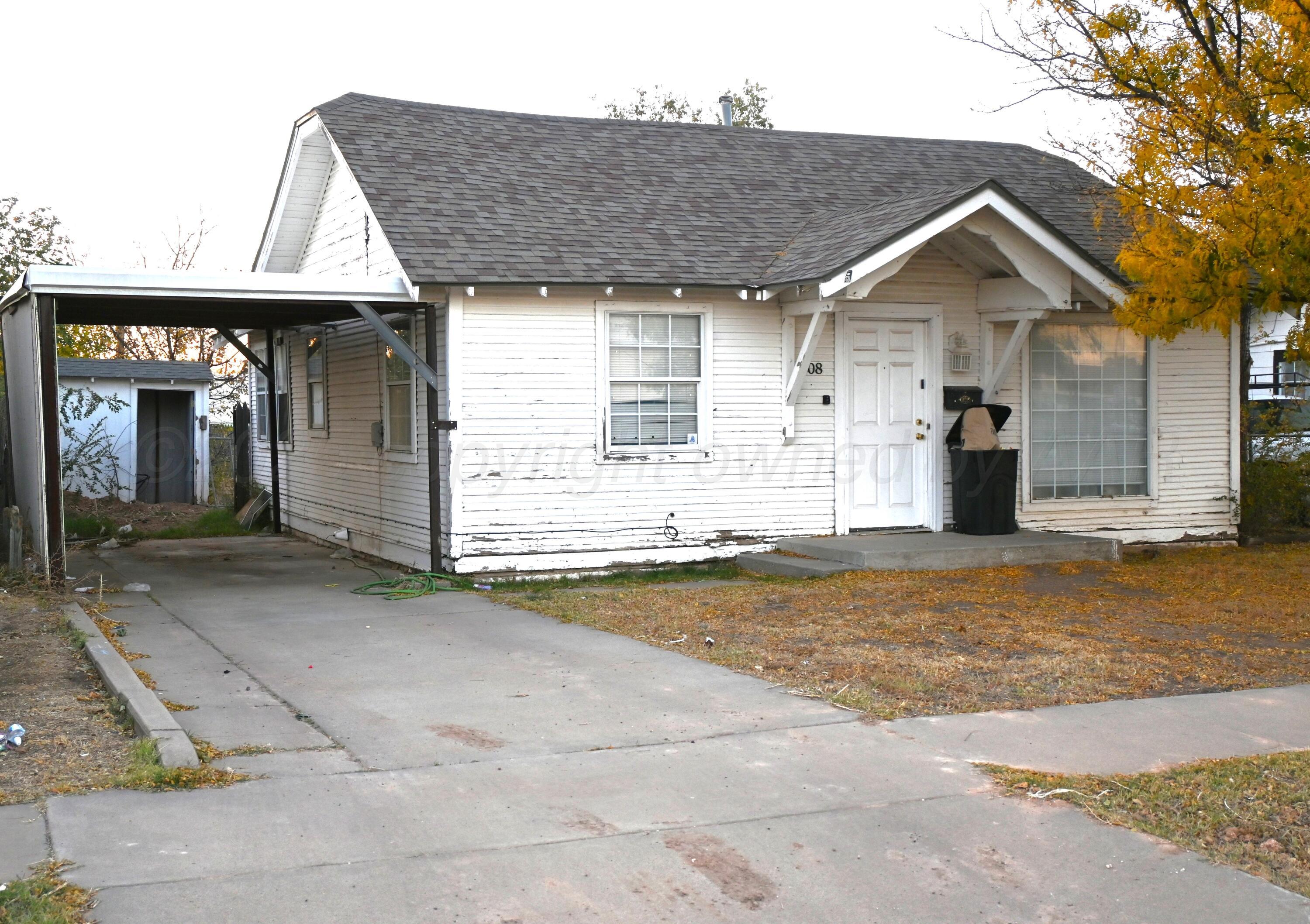 a view of a house with a yard and garage