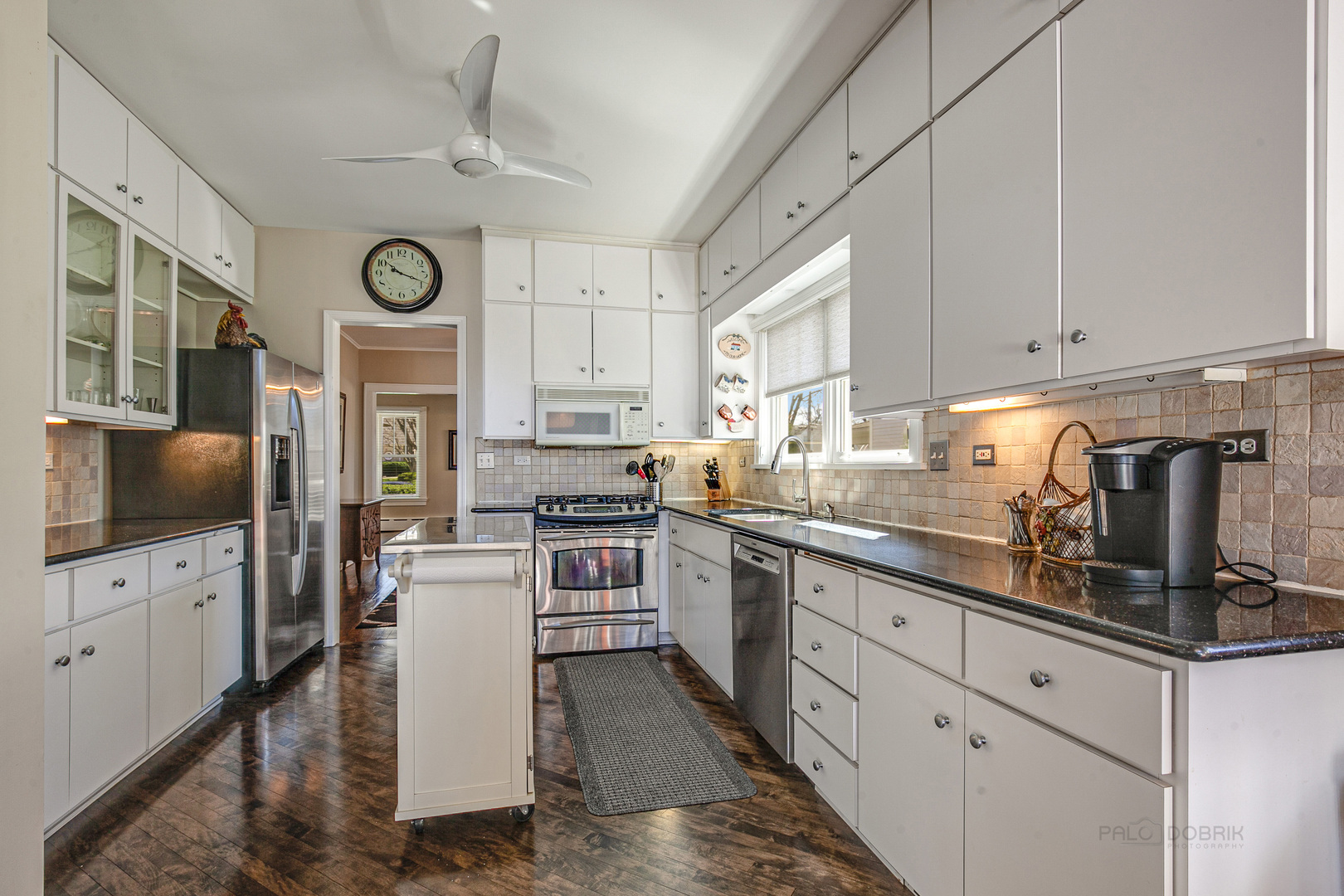 1050 Springfield Avenue Deerfield, IL 60015 - Photo 6 of 20 a kitchen with cabinets a window and stainless steel appliances