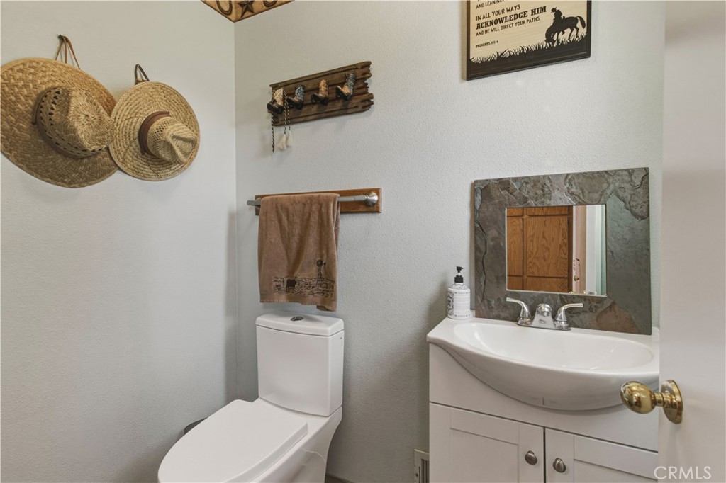 3856 North Gardner Avenue Merced, CA 95340 - Photo 18 of 59 a bathroom with a toilet a sink and mirror